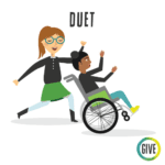 Duet. A student wearing glasses dances with a student in a wheelchair